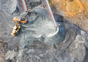 A top-down view showcasing mining operations with excavators and conveyor belts.
